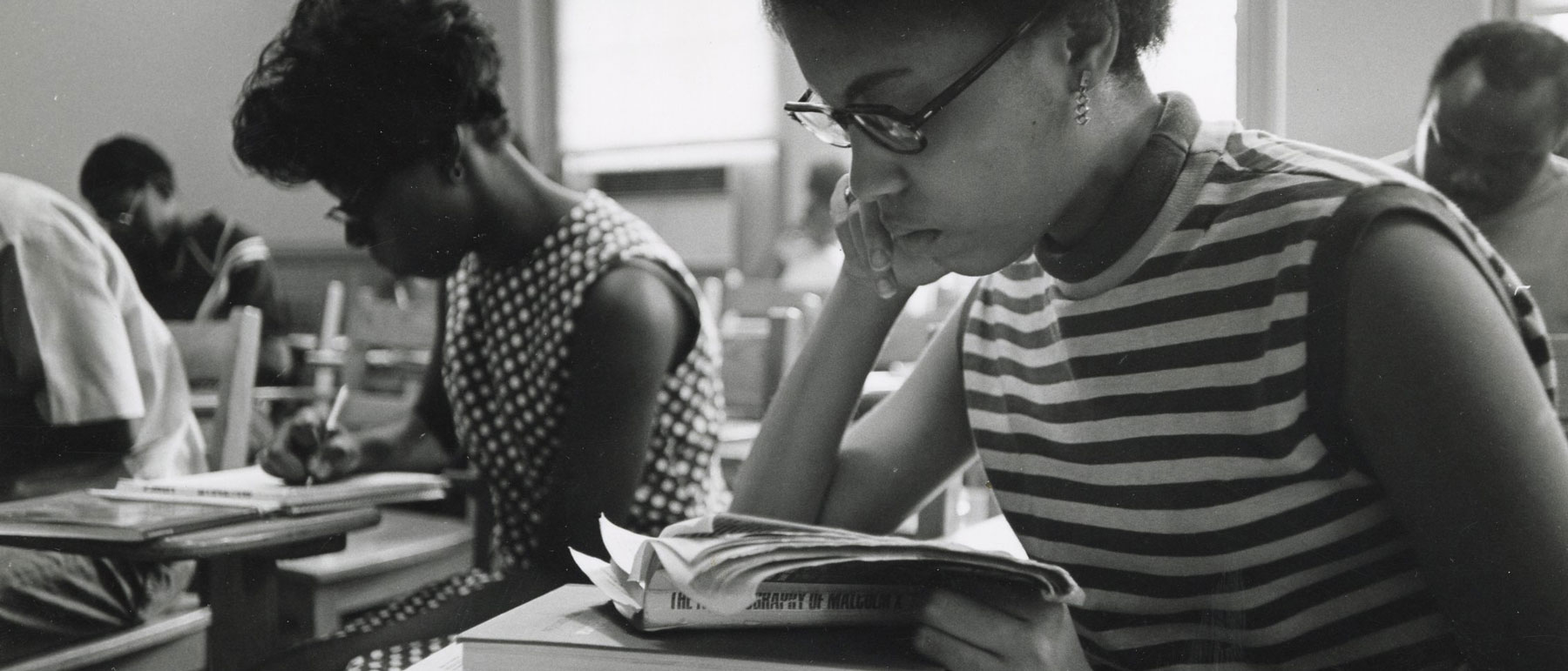 v.c.u. students in a 1960s classroom reading the biography of malcolm x